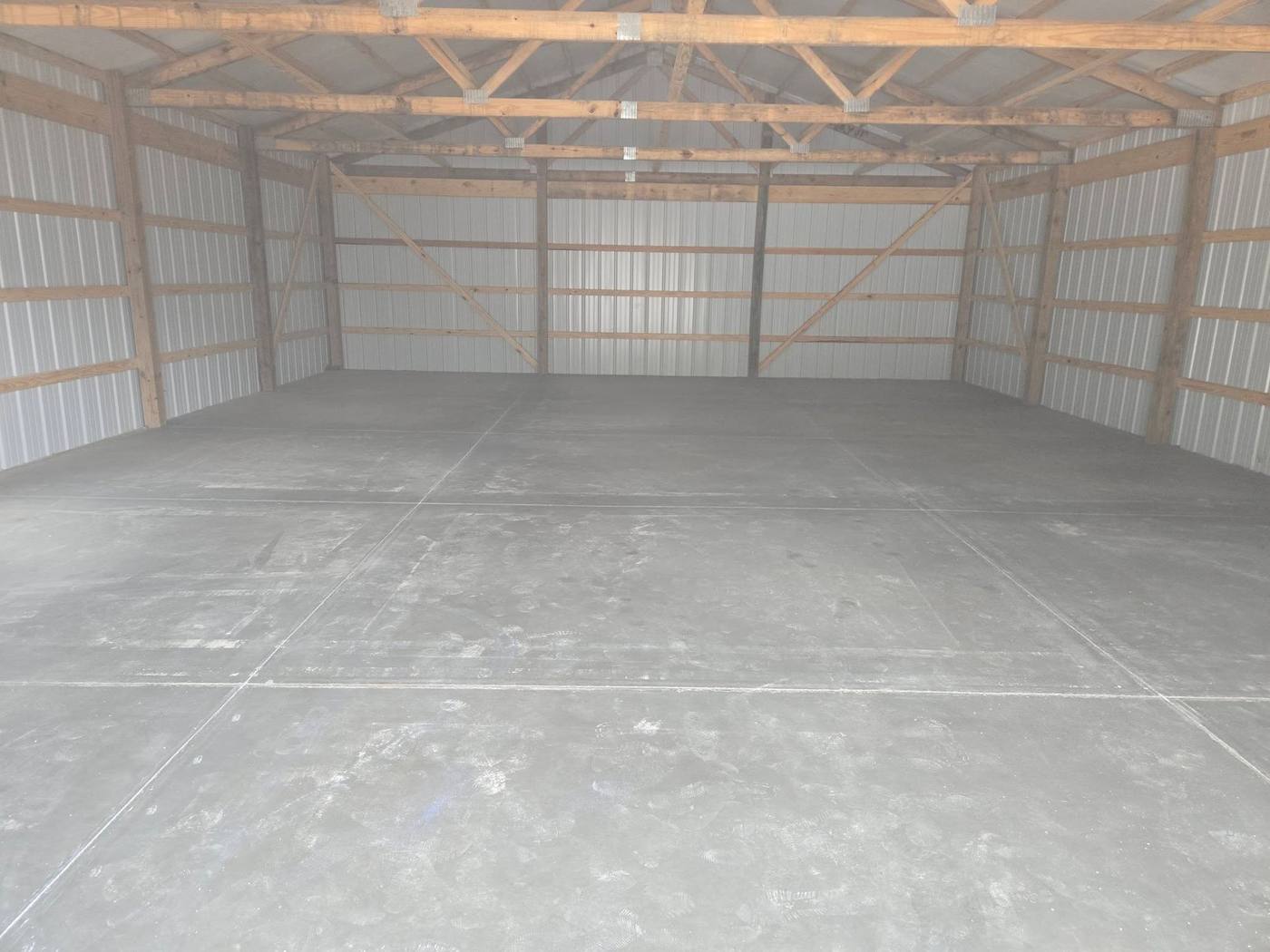 Finished concrete floor inside a wood-framed pole barn